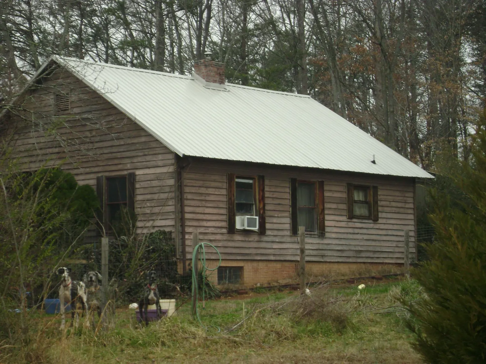 White metal roof on an old wood sided farmhouse, from a Metal Roof Installation job in Shubuta